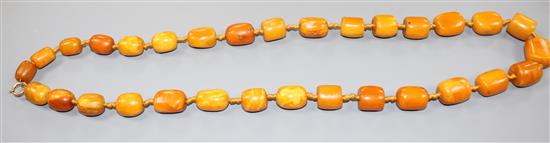 A single strand barrel shaped amber bead necklace, 86cm.